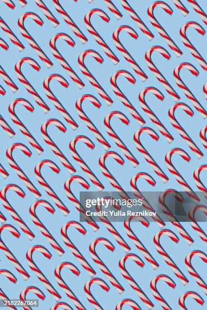 candy canes on the blue background - candy cane lollipops stock pictures, royalty-free photos & images