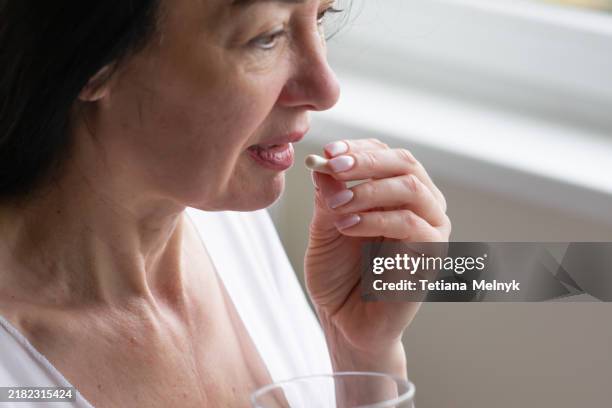 hormonal therapy. woman 50 years old - tomar remédio imagens e fotografias de stock