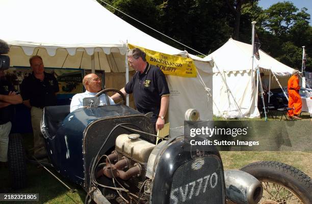 Stirling Moss at the wheel of a Ford Frontenac similar to that driven by his father Alfred in the 1924 Indianapolis 500. Goodwood Festival of Speed,...