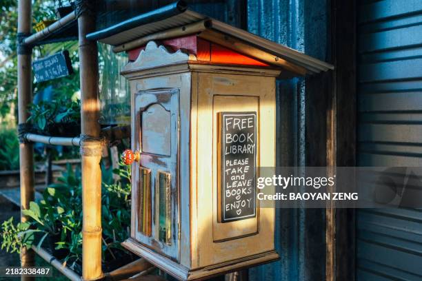 little wooden free book box library on the wall - free of charge stock pictures, royalty-free photos & images