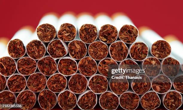 pile stacked cigarettes - tobacco product stock pictures, royalty-free photos & images