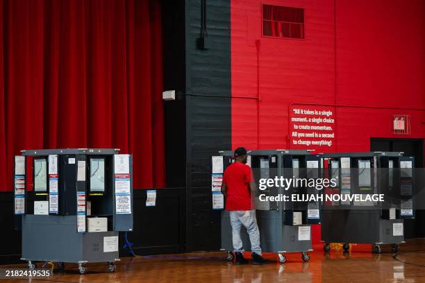 Voter casts his ballot in a polling place on Election Day in College Park, Georgia, November 5, 2024.