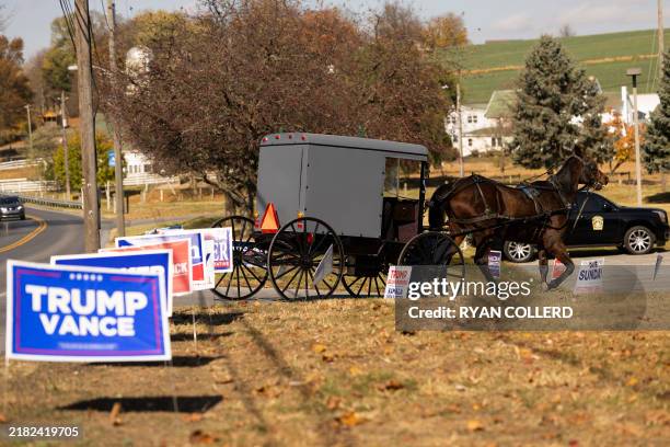 An Amish horse and buggy makes its way toward a polling location at the Leacock Township Municipal building in Intercourse, Pennsylvania, on Election...