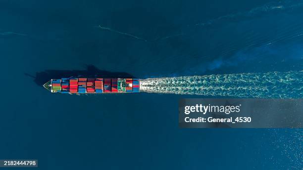 aerial top view of container ship in blue sea. - containerschip stockfoto's en -beelden