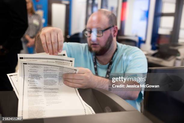 Gwinnett County election worker processes absentee ballots at the Gwinnett Voter Registrations and Elections on November 5, 2024 in Lawrenceville,...