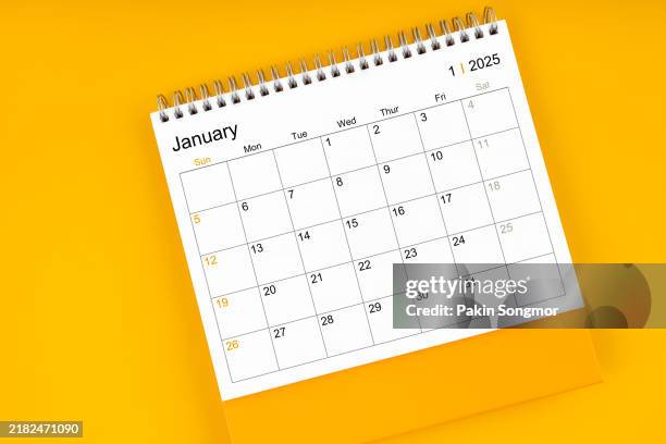 january 2025 desk calendar on yellow color background; empty space for your appointment text. - calendar stock pictures, royalty-free photos & images