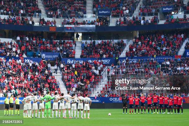 Players of CA Osasuna and of Real Valladolid, match officials and fans take part in a minute's silence in remembrance of the Victims of the...