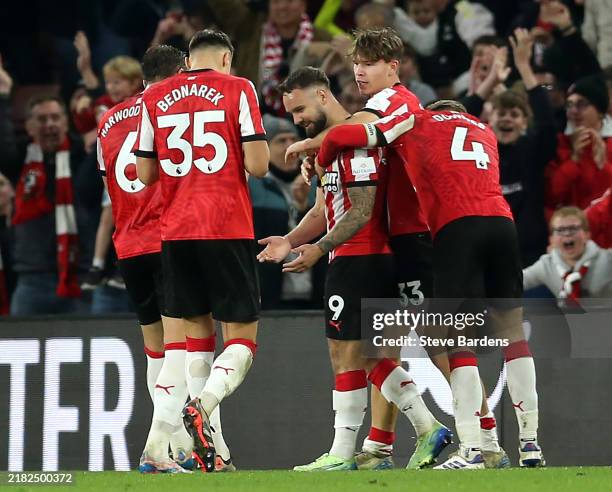 Adam Armstrong of Southampton celebrates scoring his team's first goal with teammates during the Premier League match between Southampton FC and...