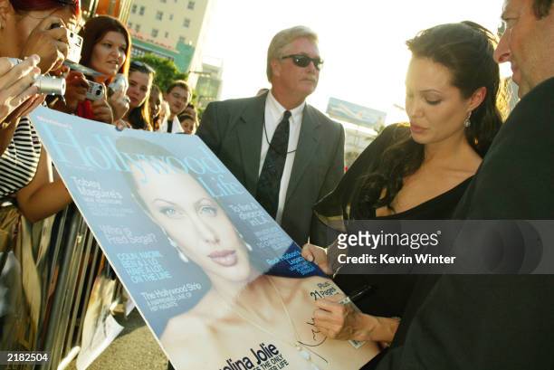 Actress Angelina Jolie signs autographs for fans at the world premiere of the film "Lara Croft Tomb Raider: The Cradle of Life" at Grauman's Chinese...