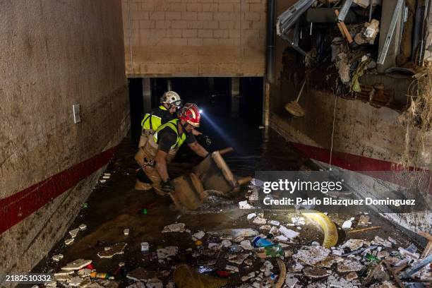 Members of the Emergency Military Unit search for a missing person in a residential carpark after heavy rain and flooding hit large parts of the...
