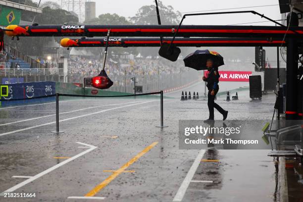 Rain falls outside the Oracle Red Bull Racing garage prior to qualifying ahead of the F1 Grand Prix of Brazil at Autodromo Jose Carlos Pace on...