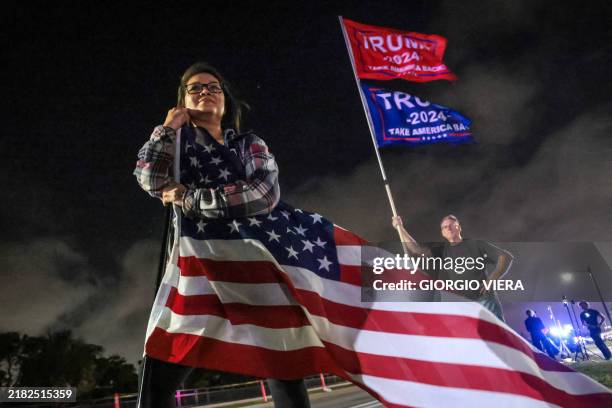 Supporters of former US president and Republican presidential candidate Donald Trump gather near his Mar-a-Lago resort in Palm Beach, Florida, on...