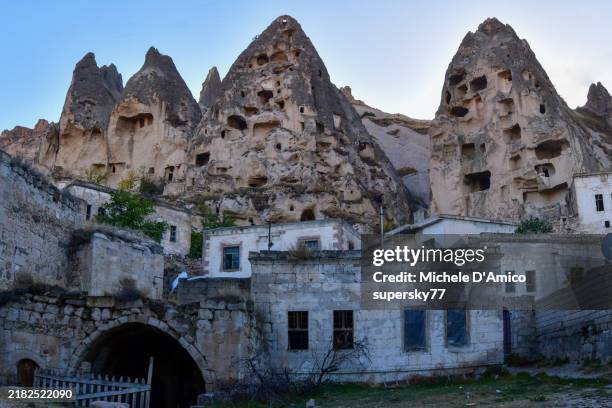 fairy chimneys with ancient cave dwellings - urgup stock pictures, royalty-free photos & images