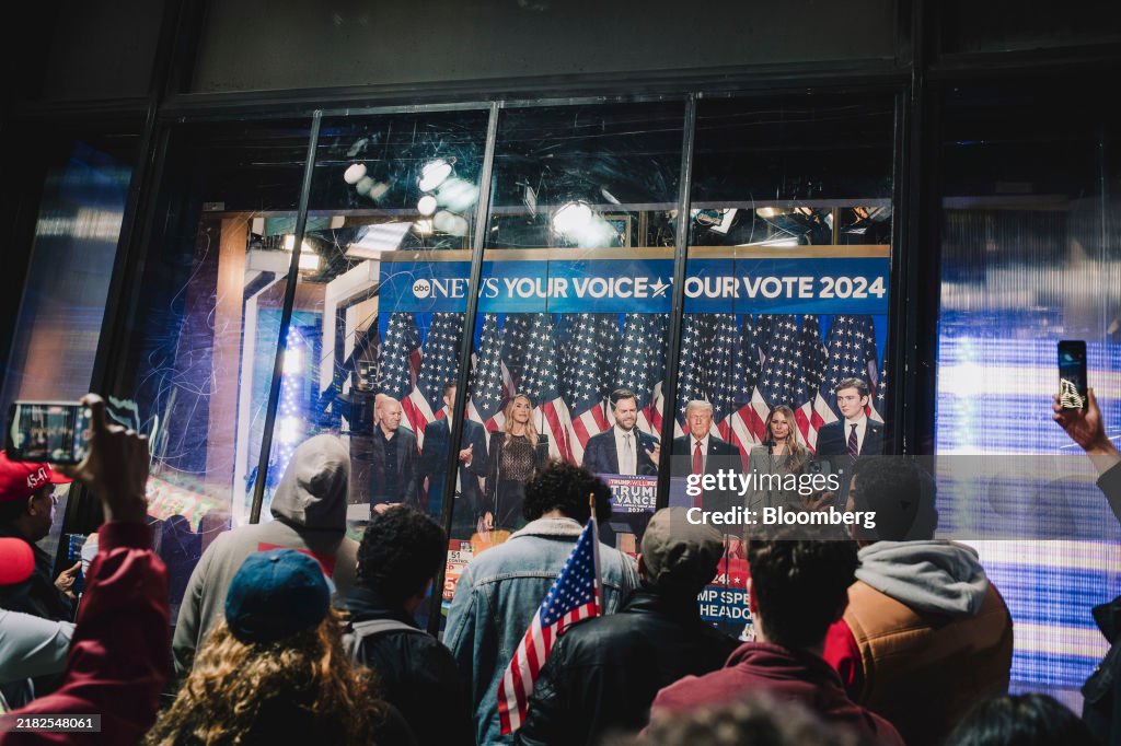 Watching Election Onlookers watch a broadcast of former US President Donald Trump... News ...