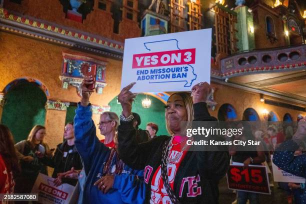 Supporters and organizers of Amendment 3 and Proposition A celebrate the results of the election at a watch party at Uptown Theater in Kansas City,...