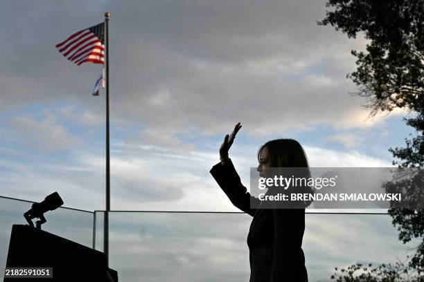 Vice President Democratic presidential candidate Kamala Harris waves at supporters as she walks off stage after speaking at Howard University in...