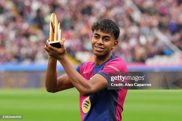 Lamine Yamal of FC Barcelona acknowledges the fans as he displays his 2024 Kopa Trophy prior to the La Liga EA Sports match between FC Barcelona and...