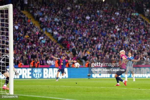 Dani Olmo of FC Barcelona scores his team's first goal as Joan Garcia of RCD Espanyol fails to make a save during the La Liga EA Sports match between...