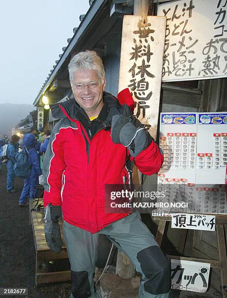 Hartwig Gauder , former German Olympic champion, gestues as he celebrates after reaching the summit of Mt. Fuji 776-metre , 19 July 2003. Gauder is...