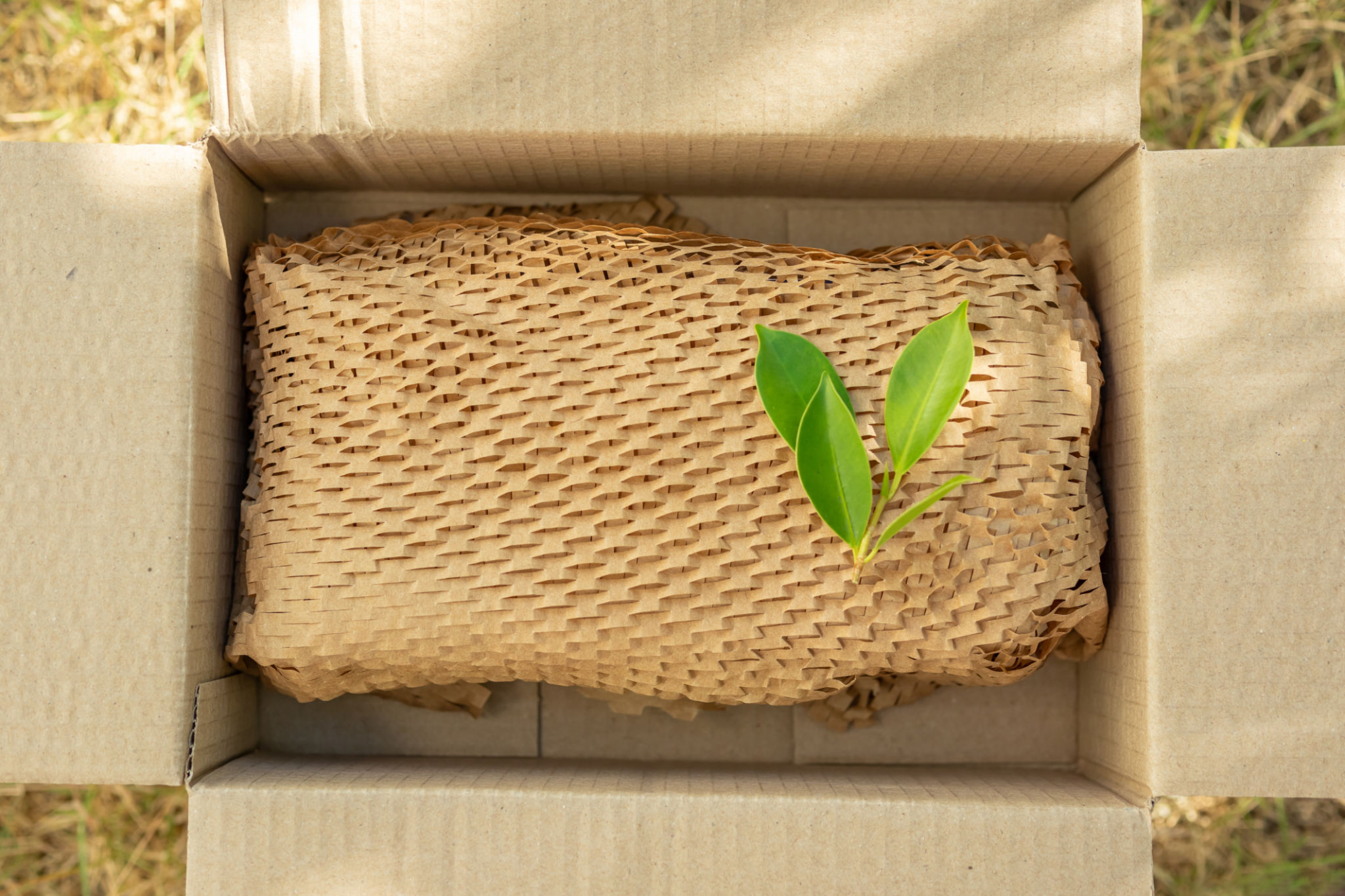 Green leaf on eco friendly brown paper honeycomb wrap for product packaging parcel carton box Green leaf on eco friendly brown paper honeycomb wrap for product packaging parcel carton box