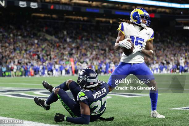 Demarcus Robinson of the Los Angeles Rams catches a pass in front of Riq Woolen of the Seattle Seahawks to win the game in overtime at Lumen Field on...