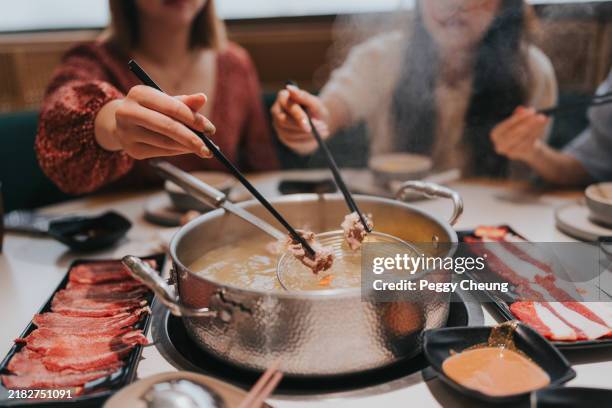 happy generation z girls tavelling in zhuhai, greater bay area, china, and having hotpot in a restaurant - steamboat stock pictures, royalty-free photos & images