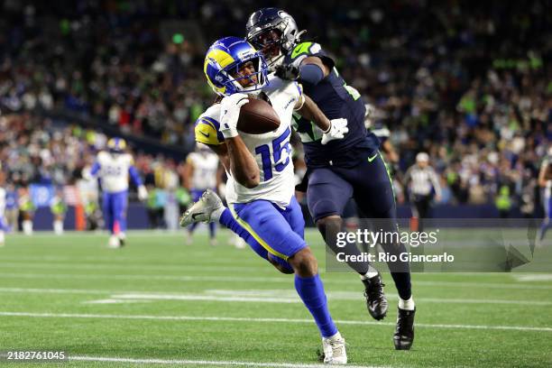 Demarcus Robinson of the Los Angeles Rams catches a pass for a touchdown in front of Riq Woolen of the Seattle Seahawks to win the game in overtime...