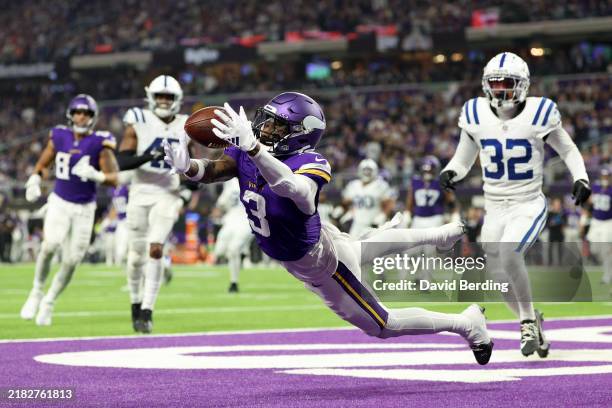 Jordan Addison of the Minnesota Vikings catches a touchdown pass during the third quarter against the Indianapolis Colts at U.S. Bank Stadium on...