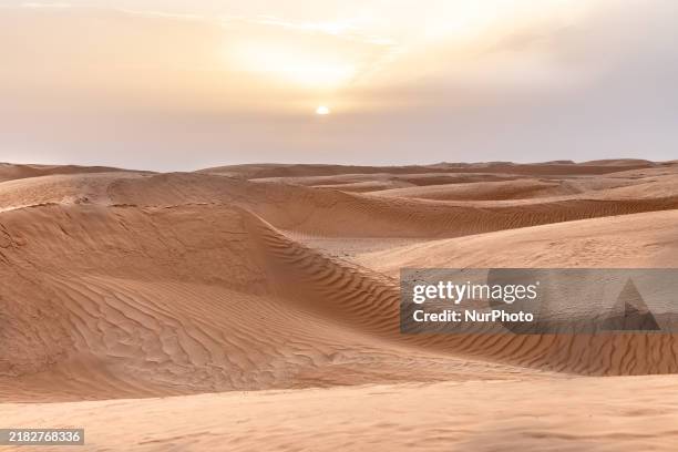 Sunset is seen over dunes of Eastern Sahara desert on on October 30, 2024 near Douz, Tunisia.