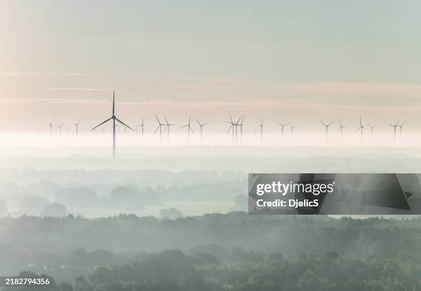 wind turbines at dawn. - mill stock pictures, royalty-free photos & images