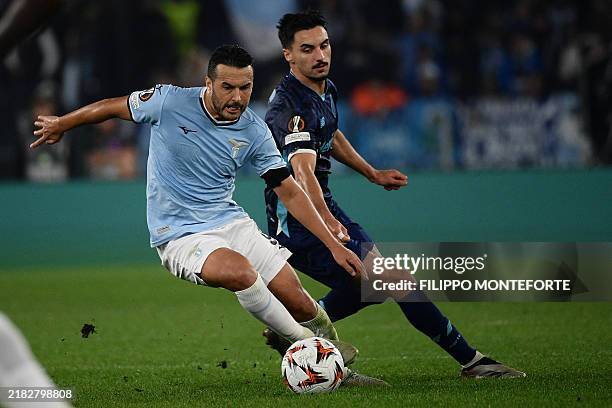 Lazio's Spanish forward Pedro Rodriguez fights for the ball with FC Porto's Canadian midfielder Stephen Eustaquio during the UEFA Europa League...