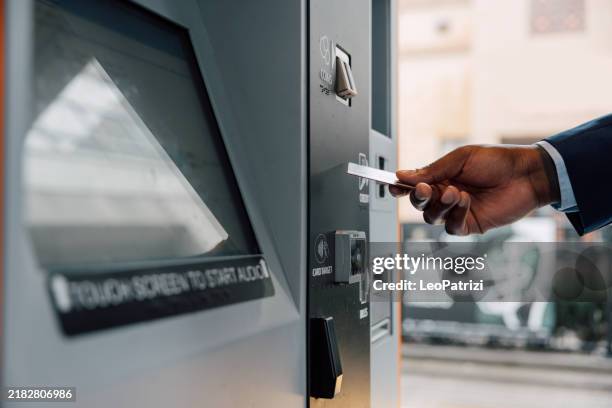 businessman buying a ride ticket from vending machine using contactless payment - train ticket stock pictures, royalty-free photos & images