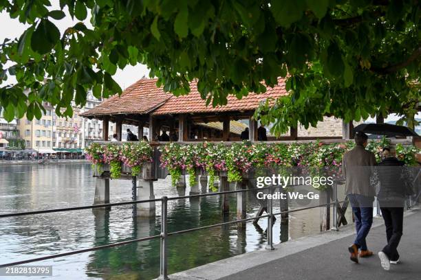 die kapellbrücke über die reuss in luzern, schweiz an einem regnerischen tag. - kapellbrücke stock-fotos und bilder