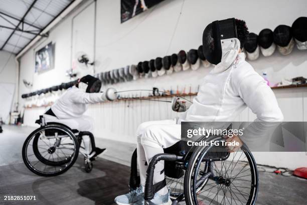 people practicing fencing at a health club - foil sword stock pictures, royalty-free photos & images