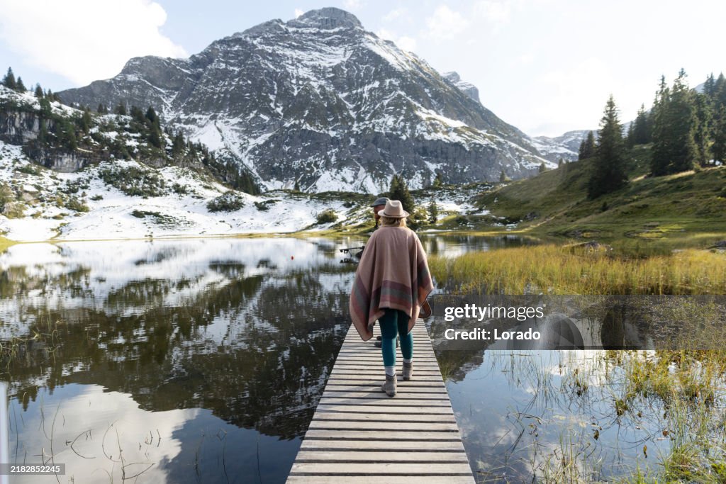 Beautiful blonde woman during an alpine forest bathing meditation trip