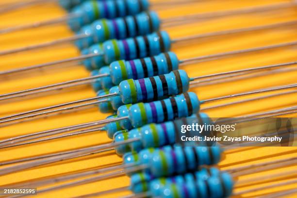 carbon composition resistors isolated on yellow background - resistor stock pictures, royalty-free photos & images