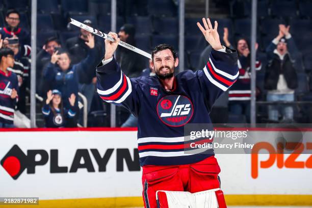 Goaltender Connor Hellebuyck of the Winnipeg Jets is all smiles as he salutes the fans after receiving first star honours following a 1-0 shutout...