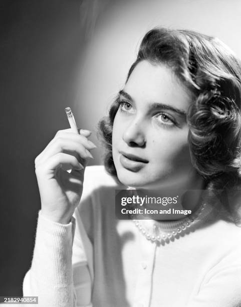 American actress Suzanne Pleshette poses as she holds her cigarette in New York, New York, circa 1956.