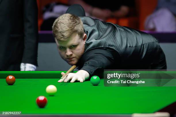 Aaron Hill of Ireland plays a shot in the second round match against Mark Allen of Northern Ireland on day 2 of 2024 International Championship at...