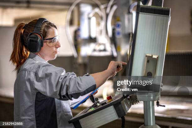 skilled operator adjusts industrial waterjet cutter - calibration stock pictures, royalty-free photos & images