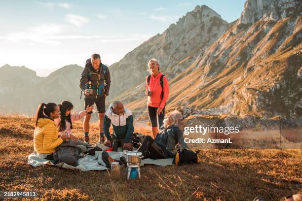 diverse friends enjoying fresh air and tea at hill summit - slovenia stock pictures, royalty-free photos & images