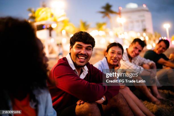 young friends talking on the beach - mexico beach night stock pictures, royalty-free photos & images