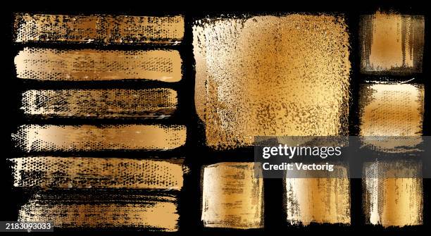 a collection of gold, textured brush strokes - brushing stock illustrations