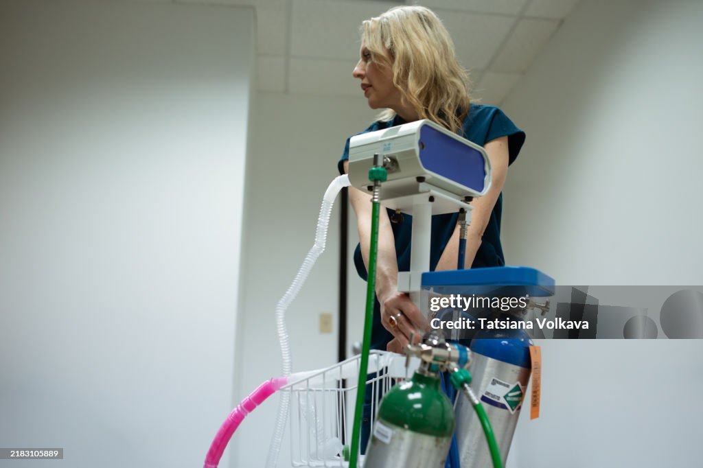 Female doctor readying a pain relief device that combines oxygen and nitrous oxide for effective comfort and anxiety reduction.