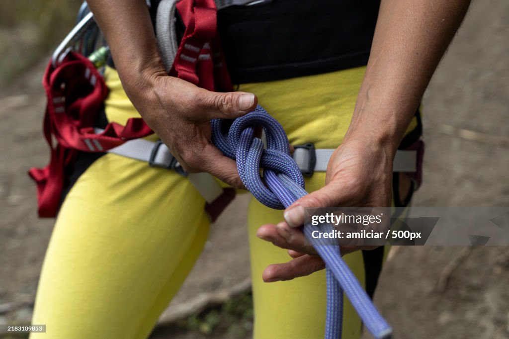 Midsection of man holding rope