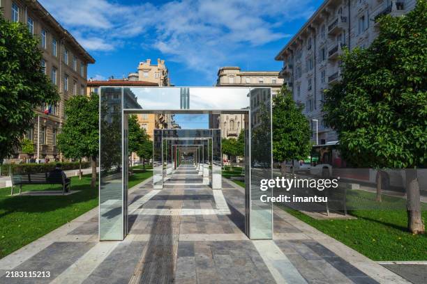 modern installation of mirrored arches contemporary art in infrastructure of city - installation art stock pictures, royalty-free photos & images