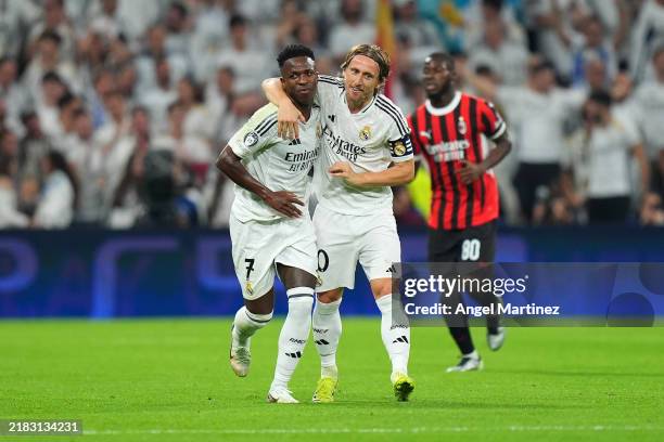 Vinicius Junior of Real Madrid celebrates with teammate Luka Modric after scoring his team's first goal from the penalty-spot during the UEFA...
