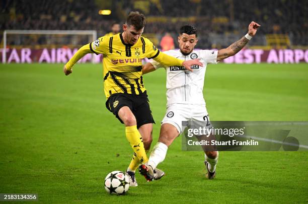 Pascal Gross of Borussia Dortmund is challenged by Jusuf Gazibegovic of SK Sturm Graz during the UEFA Champions League 2024/25 League Phase MD4 match...