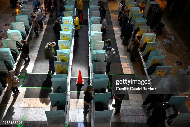 Voters cast their ballots at a polling station inside the Galleria at Sunset mall on November 05, 2024 in Las Vegas, Nevada. Americans cast their...