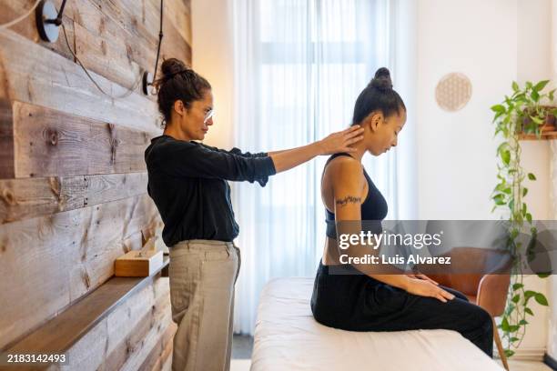neck and shoulder adjustment for enhanced alignment in chiropractic therapy - sjukgymnast bildbanksfoton och bilder